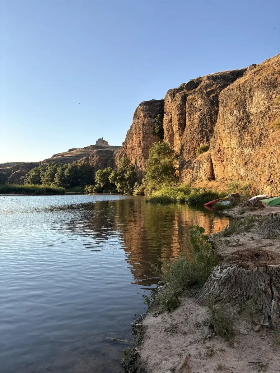 Paredes de roca de las Hoces del Duratón reflejadas en el río al atardecer